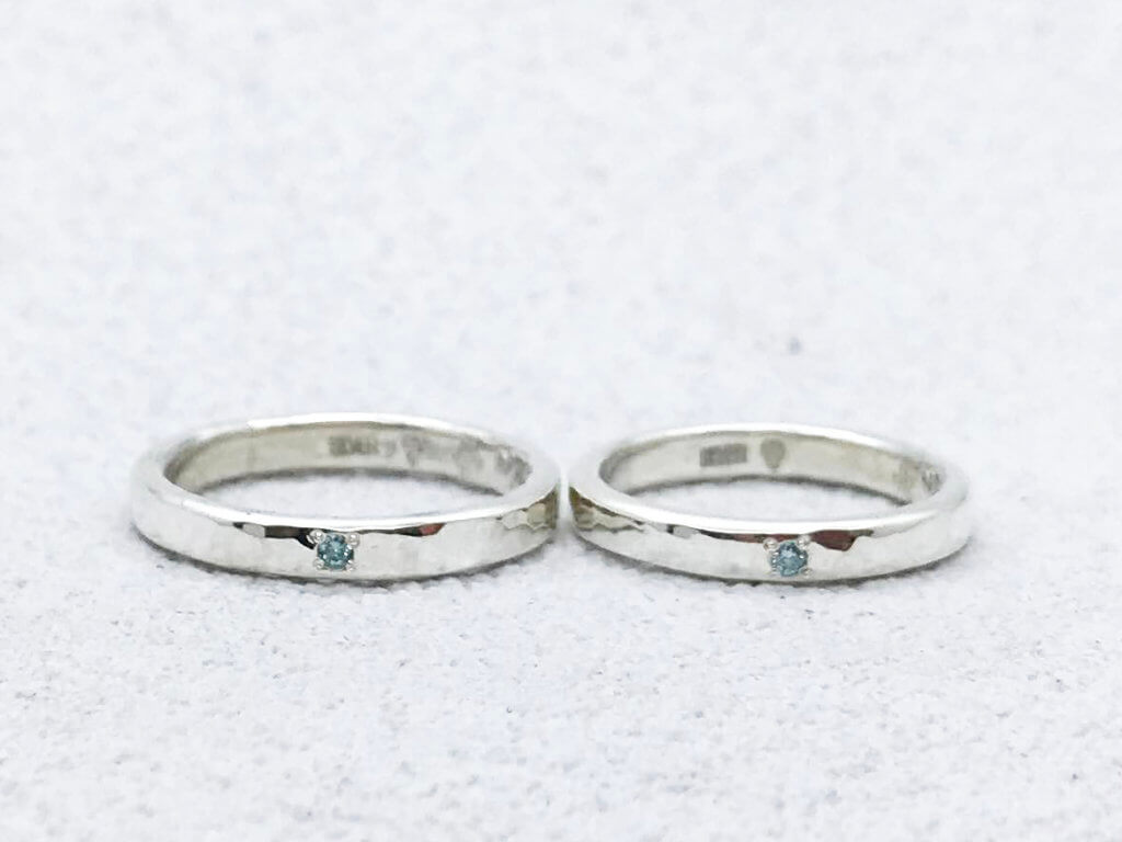 Pair of hammered rings with sparkling ice blue diamonds