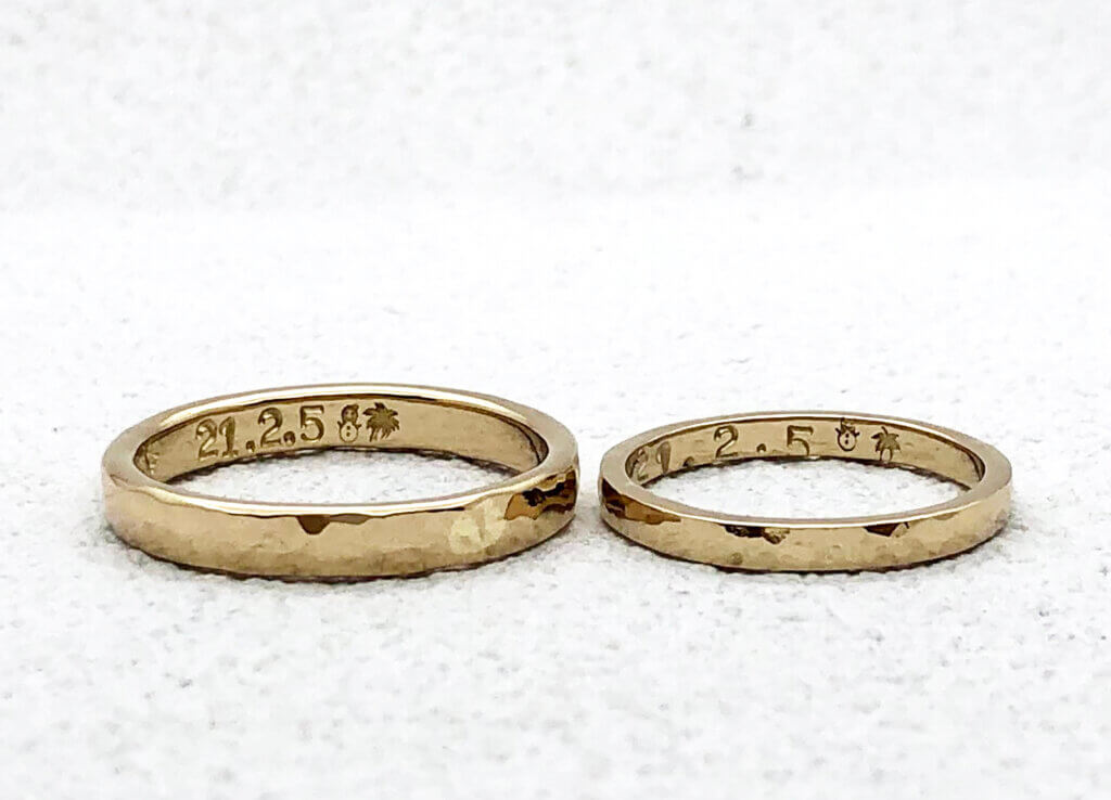 Hammered wedding band made of champagne gold with cute hand stamped engraving