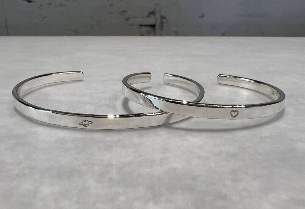 Silver bangles with matching engraved center accent